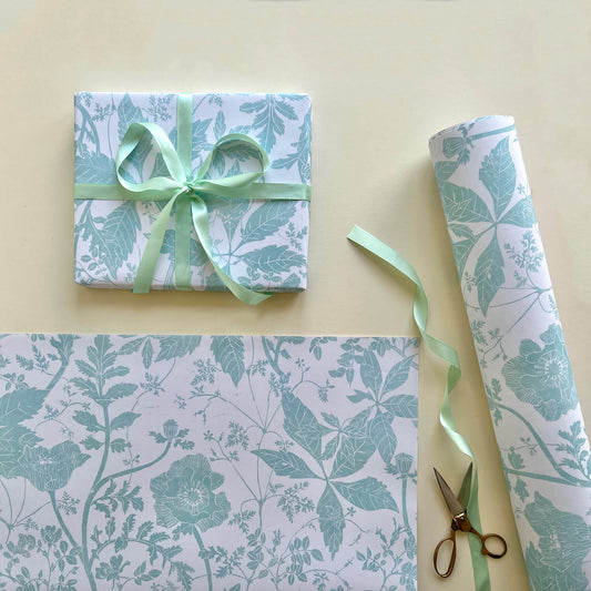 Lino print gift wrap with poppy flowers and wild roses in green patterned papers for gifting