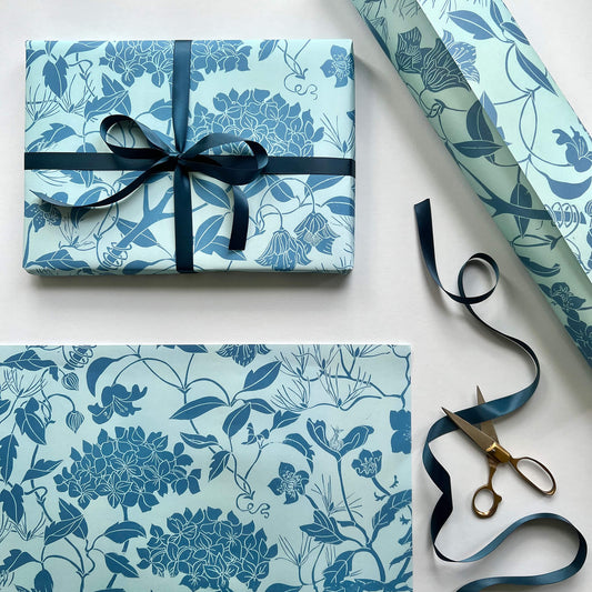 Laura Sowerby's Linocut print gift wrap featuring garden plants including hydrangea and clematis