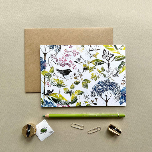 Lino print card featuring wallpaper design by Laura Sowerby of birds and botanical leaves and flowers