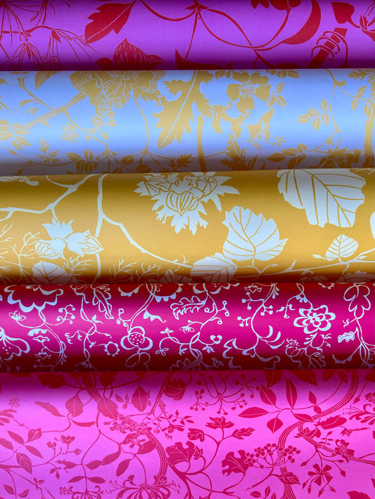 Wrapping paper featuring lino print design inspired by Botanical subjects as well as an 18th-century embroidery of a coverlet with crewelwork pattern